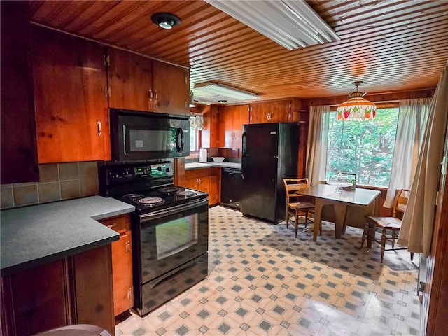 1638 Lake Rd, Pa, PA 16137 - kitchen with black appliances, light floors, wooden ceiling, brown cabinetry, and backsplash