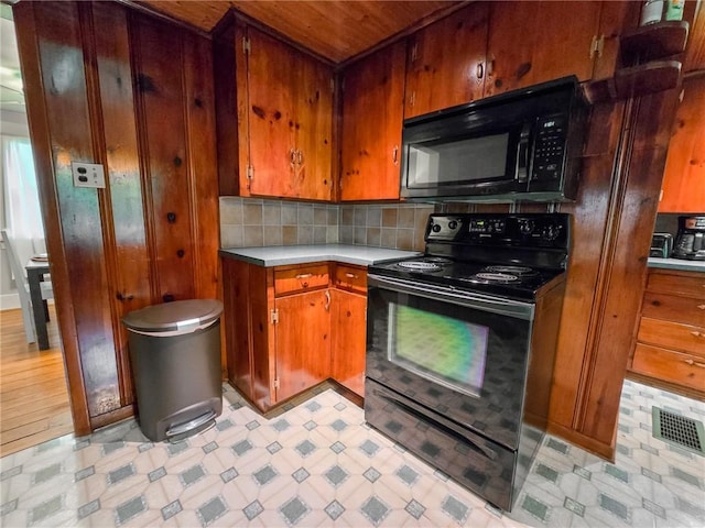 1638 Lake Rd, Pa, PA 16137 - kitchen with black appliances, light countertops, light floors, tasteful backsplash, and brown cabinets