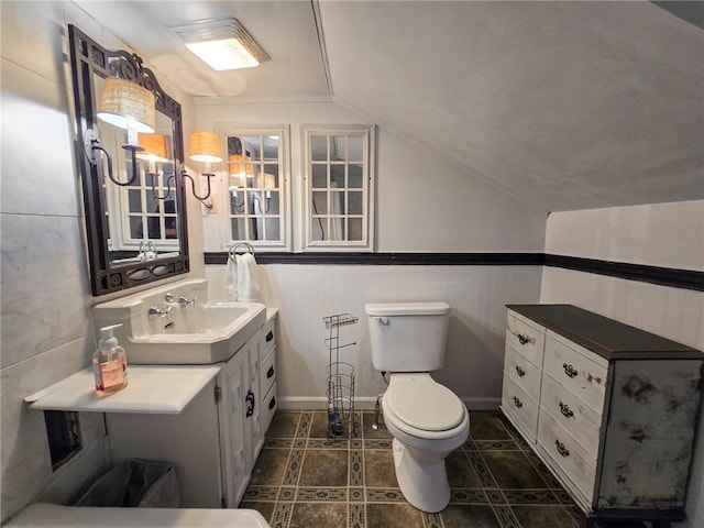 1638 Lake Rd, Pa, PA 16137 - bathroom with lofted ceiling, vanity, and wainscoting