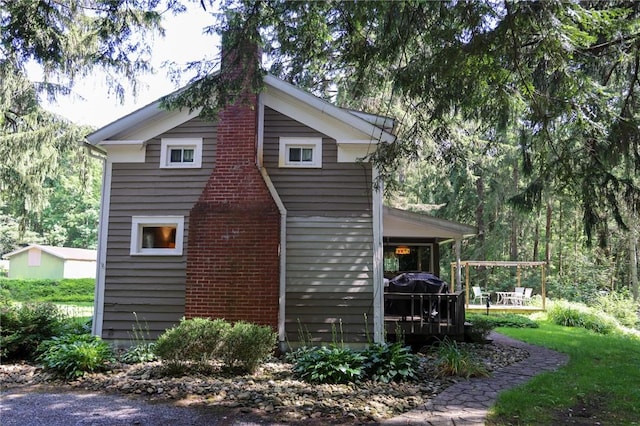 1638 Lake Rd, Pa, PA 16137 - view of property exterior with a chimney and a wooden deck
