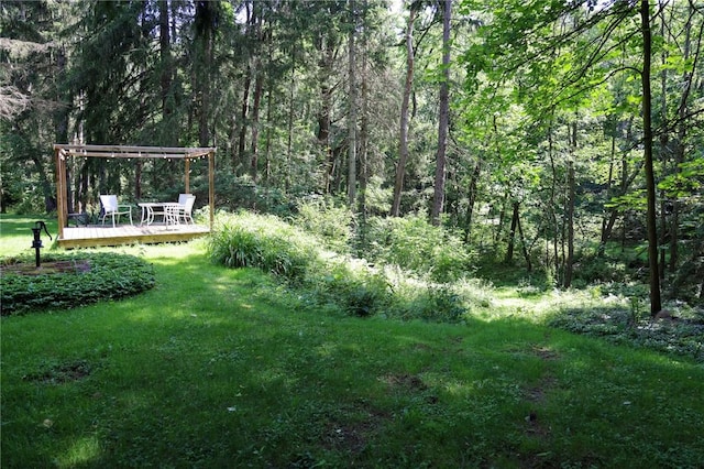 1638 Lake Rd, Pa, PA 16137 - view of green lawn featuring a wooden deck, a wooded view, and a pergola