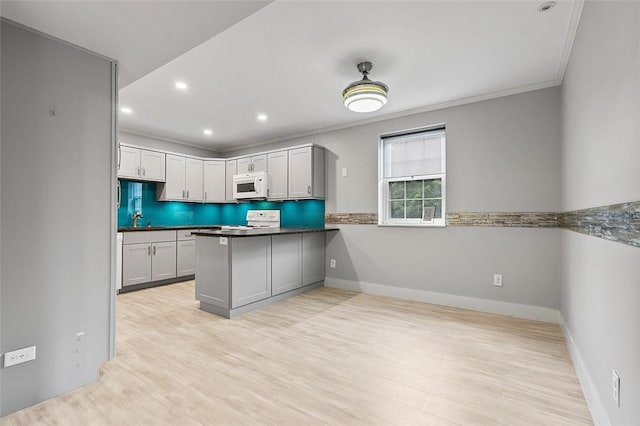 105 Camelot Dr, Mccandless, PA 15237 - kitchen with white microwave, stove, light wood-style flooring, a peninsula, and crown molding