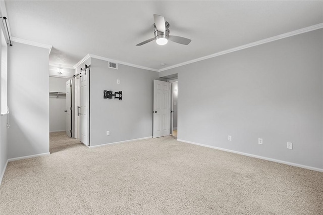105 Camelot Dr, Mccandless, PA 15237 - unfurnished bedroom featuring a barn door, ornamental molding, light colored carpet, a walk in closet, and ceiling fan