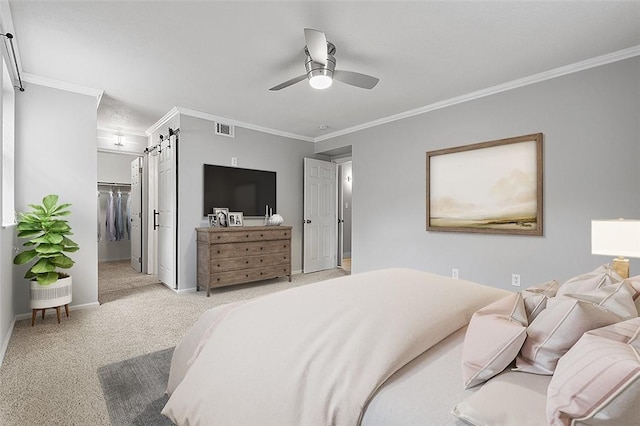 105 Camelot Dr, Mccandless, PA 15237 - bedroom featuring a barn door, crown molding, carpet flooring, a spacious closet, and a ceiling fan