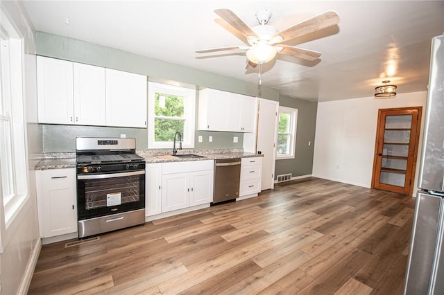 539 Park Ave, Monongahela, PA 15063 - kitchen with appliances with stainless steel finishes, light wood-style floors, and white cabinets