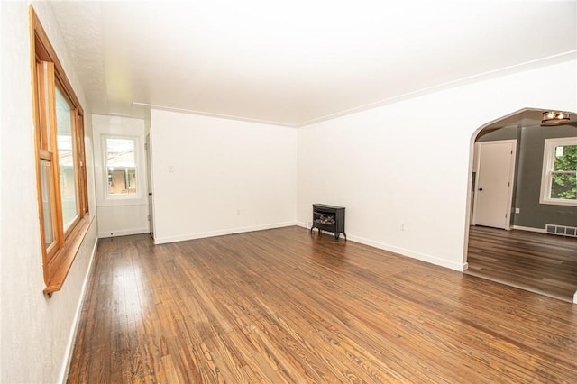 539 Park Ave, Monongahela, PA 15063 - empty room featuring wood finished floors, a wood stove, and arched walkways
