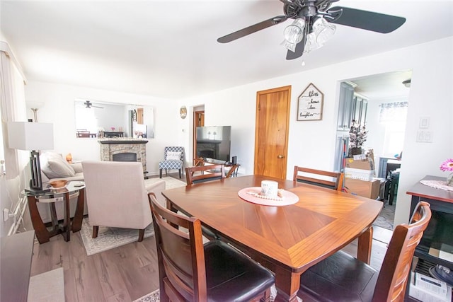 502 Lebanon Manor Dr, West Mifflin, PA 15122 - dining area featuring ceiling fan, a fireplace, and wood finished floors