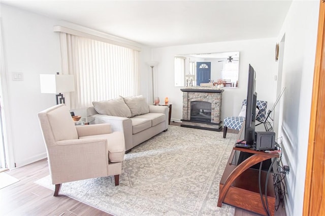 502 Lebanon Manor Dr, West Mifflin, PA 15122 - living area with wood finished floors, a stone fireplace, and a ceiling fan