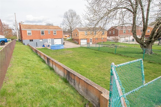 502 Lebanon Manor Dr, West Mifflin, PA 15122 - view of yard with a residential view, driveway, and a garage