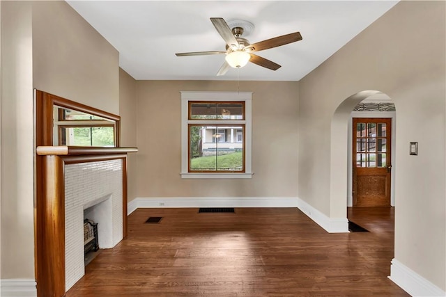 122 Haldane St, Crafton, PA 15205 - unfurnished living room featuring arched walkways, a fireplace, wood finished floors, and ceiling fan
