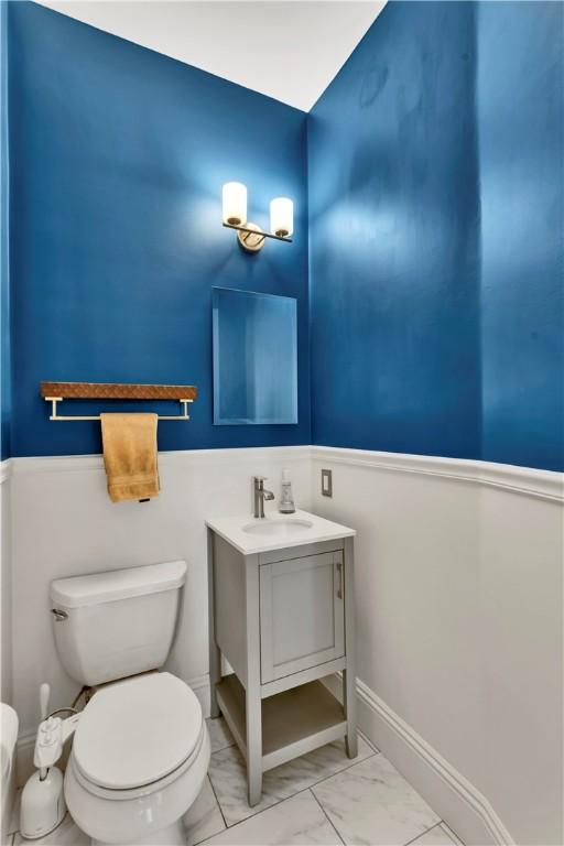 122 Haldane St, Crafton, PA 15205 - bathroom featuring marble finish floors, vanity, and a wainscoted wall