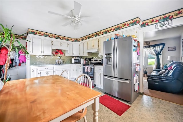 965 Dalton Ave, Hermitage, PA 16148 - kitchen with appliances with stainless steel finishes, under cabinet range hood, a ceiling fan, decorative backsplash, and light countertops