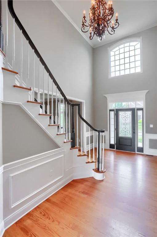 4127 Duckhorn Dr, Moon/Crescent Twp, PA 15108 - foyer featuring a towering ceiling, a chandelier, stairway, plenty of natural light, and wood finished floors