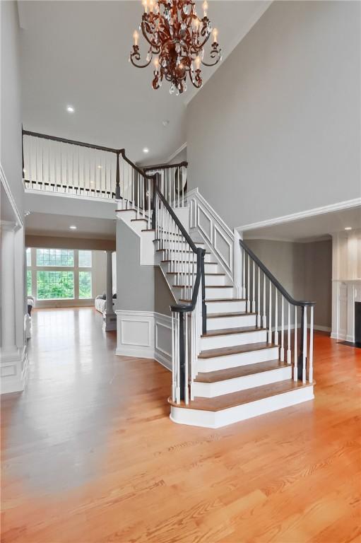 4127 Duckhorn Dr, Moon/Crescent Twp, PA 15108 - staircase with a high ceiling, a chandelier, wood finished floors, and recessed lighting