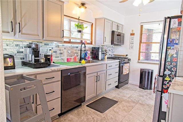 1109 N 2nd St, Jeannette, PA 15644 - kitchen featuring appliances with stainless steel finishes, decorative backsplash, light countertops, and ceiling fan