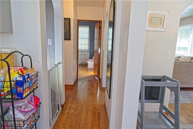 1109 N 2nd St, Jeannette, PA 15644 - corridor featuring a textured wall, wood finished floors, and arched walkways