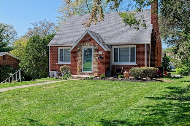 1109 N 2nd St, Jeannette, PA 15644 - tudor home featuring a chimney, brick siding, a shingled roof, and a front yard