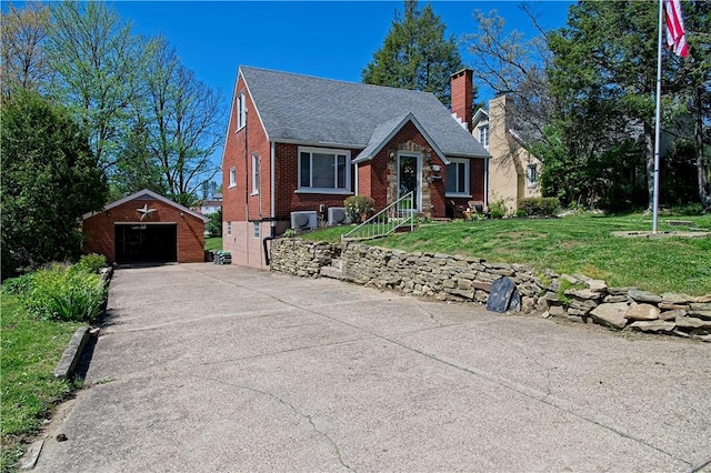 1109 N 2nd St, Jeannette, PA 15644 - tudor home featuring a detached garage, an outdoor structure, brick siding, a chimney, and roof with shingles