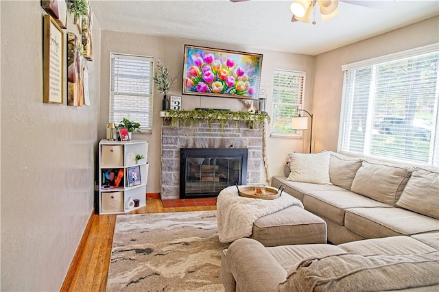 1109 N 2nd St, Jeannette, PA 15644 - living room featuring a ceiling fan, wood finished floors, and a fireplace