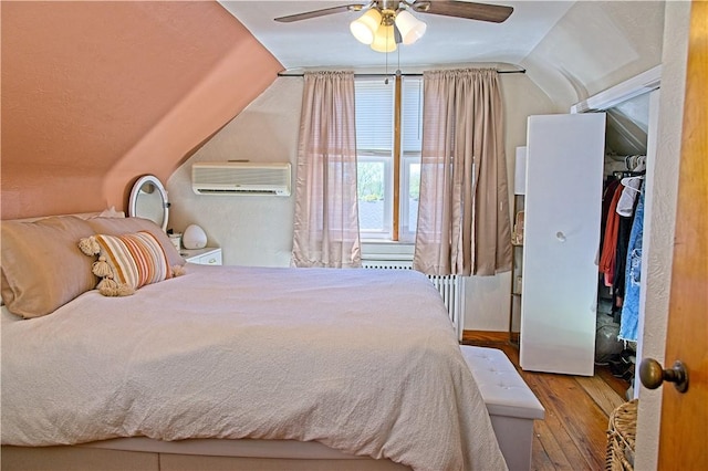 1109 N 2nd St, Jeannette, PA 15644 - bedroom with an AC wall unit, vaulted ceiling, hardwood / wood-style flooring, and a ceiling fan