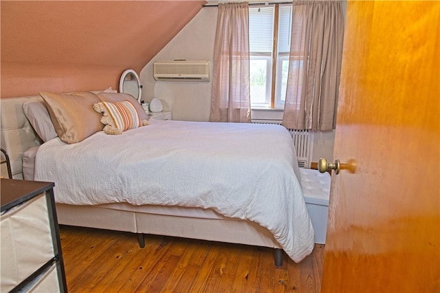 1109 N 2nd St, Jeannette, PA 15644 - bedroom featuring a wall mounted air conditioner, lofted ceiling, and hardwood / wood-style floors