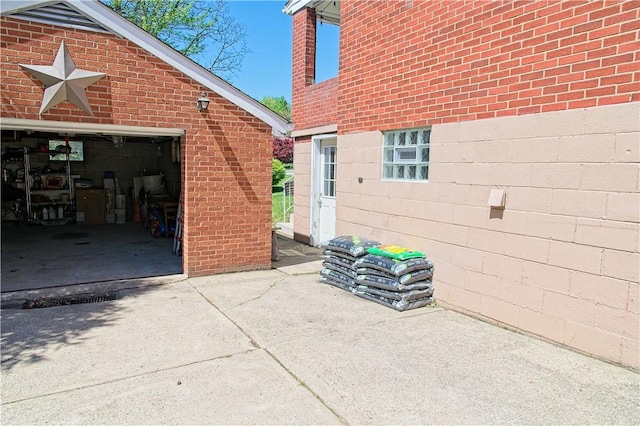 1109 N 2nd St, Jeannette, PA 15644 - view of home's exterior featuring brick siding, concrete driveway, and a garage