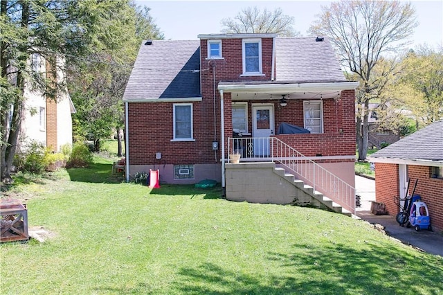 1109 N 2nd St, Jeannette, PA 15644 - view of front of home with brick siding, a front yard, and a shingled roof