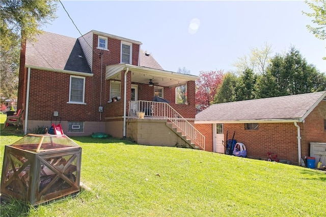 1109 N 2nd St, Jeannette, PA 15644 - back of house with brick siding, a yard, and ceiling fan