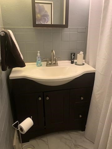 19 Charles St, Dravosburg, PA 15034 - bathroom with vanity, marble finish flooring, and tile walls