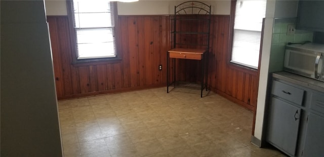 19 Charles St, Dravosburg, PA 15034 - kitchen with wood walls, a wainscoted wall, and light floors