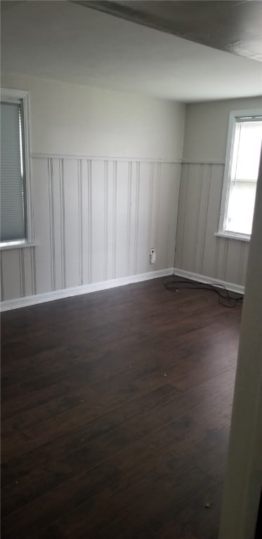 19 Charles St, Dravosburg, PA 15034 - empty room featuring dark wood-style flooring, wainscoting, and a decorative wall