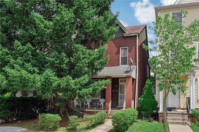 518 N Saint Clair St, East Liberty, PA 15206 - view of front facade with brick siding and a porch