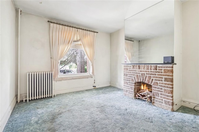518 N Saint Clair St, East Liberty, PA 15206 - unfurnished living room featuring radiator heating unit, carpet flooring, and a lit fireplace