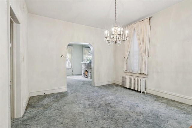 518 N Saint Clair St, East Liberty, PA 15206 - carpeted spare room featuring radiator, arched walkways, and a chandelier