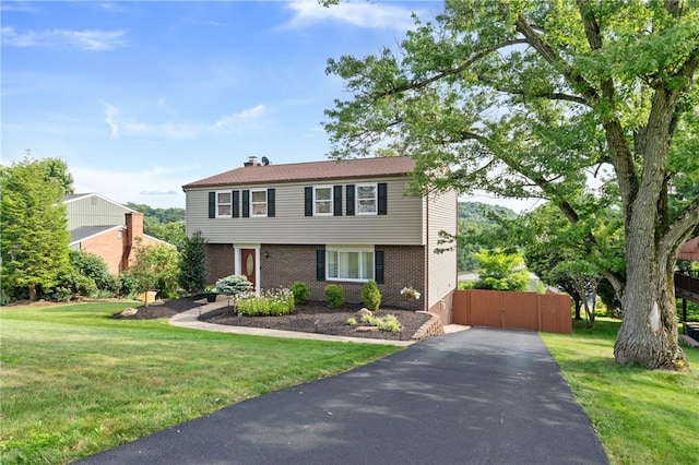249 Clare Dr, North Strabane, PA 15317 - colonial house featuring brick siding, a front yard, asphalt driveway, and a gate