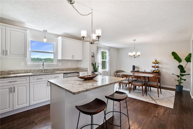 249 Clare Dr, North Strabane, PA 15317 - kitchen featuring a textured ceiling, a chandelier, dark wood-style flooring, plenty of natural light, and white cabinets