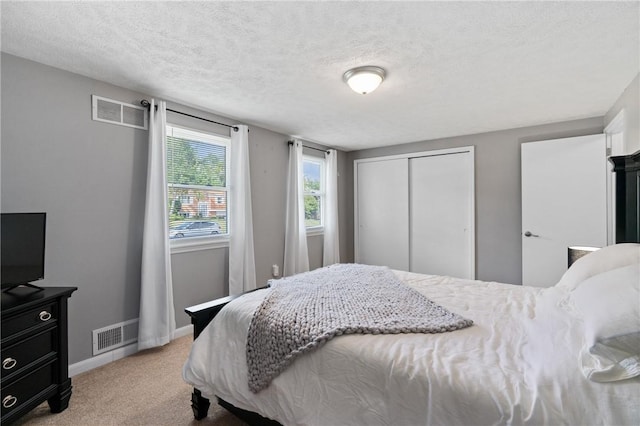 249 Clare Dr, North Strabane, PA 15317 - bedroom with light colored carpet, a closet, and a textured ceiling