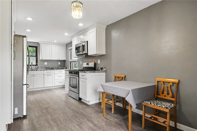 616 Highview Rd, Baldwin Twp, PA 15234 - kitchen with stainless steel appliances, wood finished floors, light stone counters, white cabinets, and recessed lighting