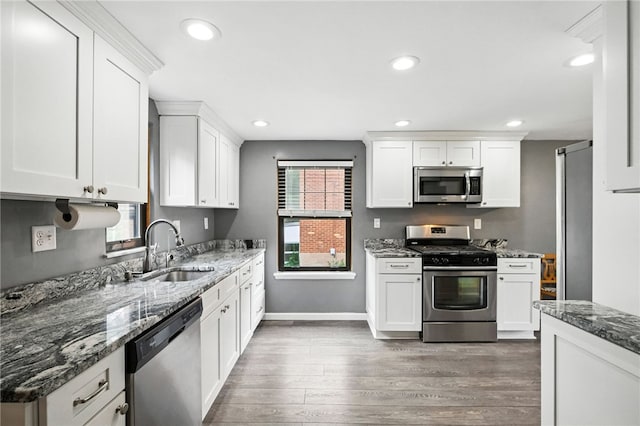616 Highview Rd, Baldwin Twp, PA 15234 - kitchen featuring appliances with stainless steel finishes, wood finished floors, white cabinets, dark stone countertops, and recessed lighting
