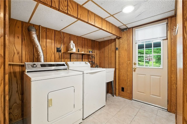 616 Highview Rd, Baldwin Twp, PA 15234 - laundry area featuring washing machine and dryer, light tile patterned flooring, and wood walls