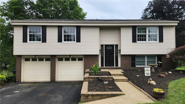2583 Richard Rd, Franklin Park, PA 15090 - split foyer home with brick siding, asphalt driveway, and a garage