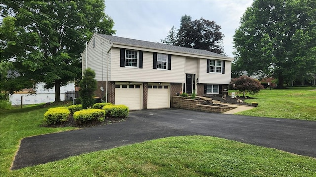 2583 Richard Rd, Franklin Park, PA 15090 - bi-level home with driveway, an attached garage, a front lawn, and brick siding