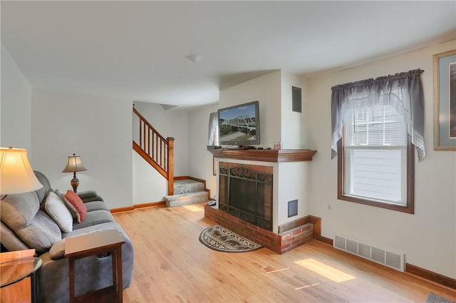 1009 Roselawn Ave, Harmony Twp, PA 15003 - living room with wood finished floors, stairs, and a fireplace