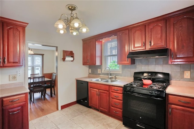 1009 Roselawn Ave, Harmony Twp, PA 15003 - kitchen with black appliances, under cabinet range hood, light countertops, and backsplash