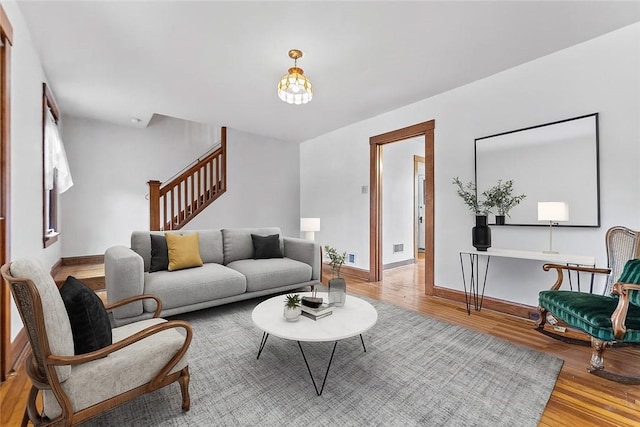 208 E 19th Ave, Munhall, PA 15120 - living area with wood finished floors, stairway, and a chandelier