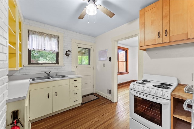 208 E 19th Ave, Munhall, PA 15120 - kitchen featuring white range with electric cooktop, light countertops, wood finished floors, and backsplash