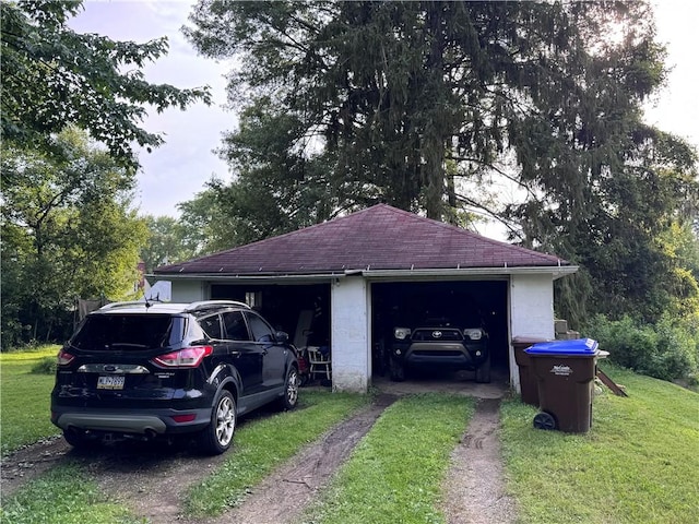 1077 Bechtol Ave, Sharon, PA 16146 - view of property exterior featuring a yard, a shingled roof, a garage, and an outbuilding