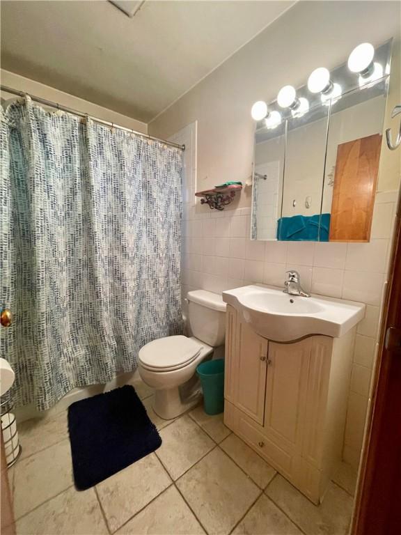 408 Ekin St, Elizabeth Twp/Boro, PA 15037 - full bathroom featuring vanity, tile walls, tile patterned floors, and curtained shower