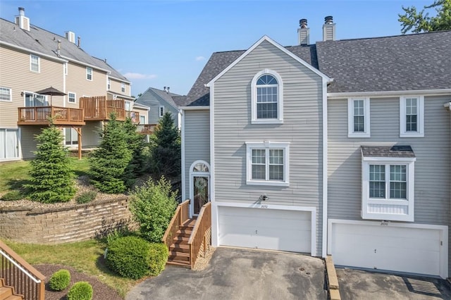 2692 Hunters Point Dr, Franklin Park, PA 15090 - view of front of house featuring stairs, a garage, asphalt driveway, a chimney, and roof with shingles