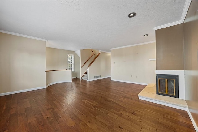 2692 Hunters Point Dr, Franklin Park, PA 15090 - unfurnished living room featuring a textured ceiling, a glass covered fireplace, ornamental molding, stairs, and hardwood / wood-style flooring